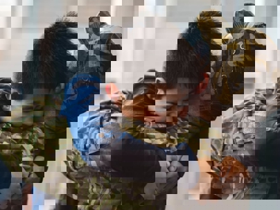 Young son hugging father after a move