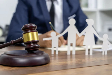 Lawyer with family figurines on his table and a gavel